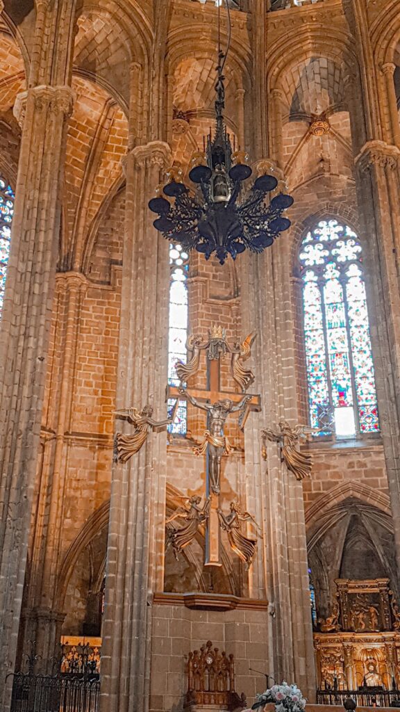 The interior of Barcelona Cathedral which Jesus on the Cross and angels beside the crucifix