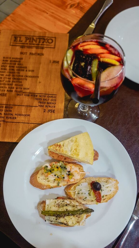 A plate of various tapas and a glass of sangria