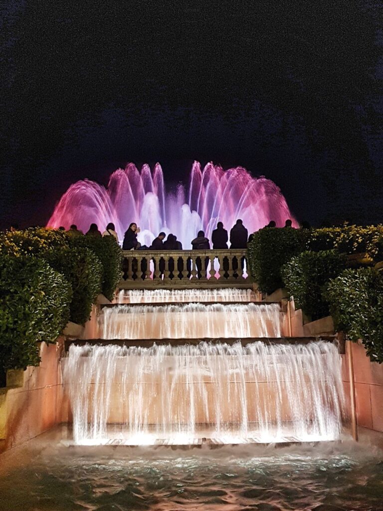 The beautiful fountain of Montjuic putting on a show with lights.