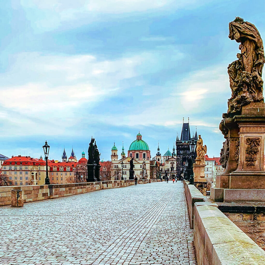 A picture of Charles Bridge and its statues overlooking a beautiful suburb of Prague. Usually filled with tourists as this is one of the top attractions to visit in Prague.