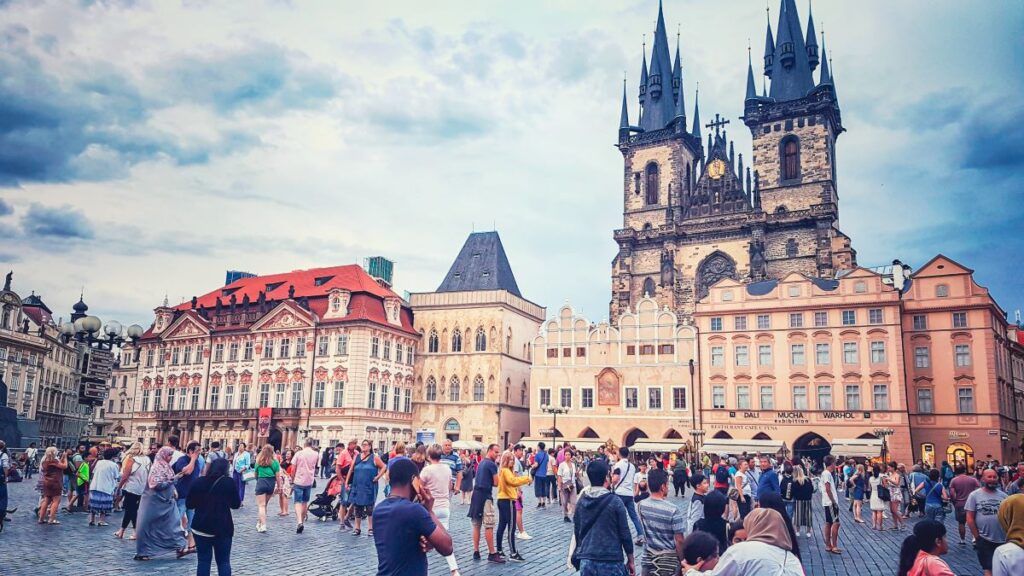 A photo of Old Town Square in the heart of Prague filled with historic buildings and people walking all over. Definitely one of the top attractions to visit in Prague.