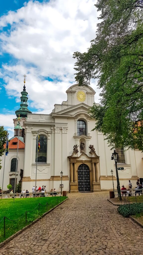 The Grand entrance to Strahov Monastery with trees on either side. 