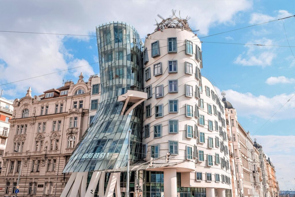 The unique structure in Prague known as the Dancing house, sitting on the corner of a street in Prague.