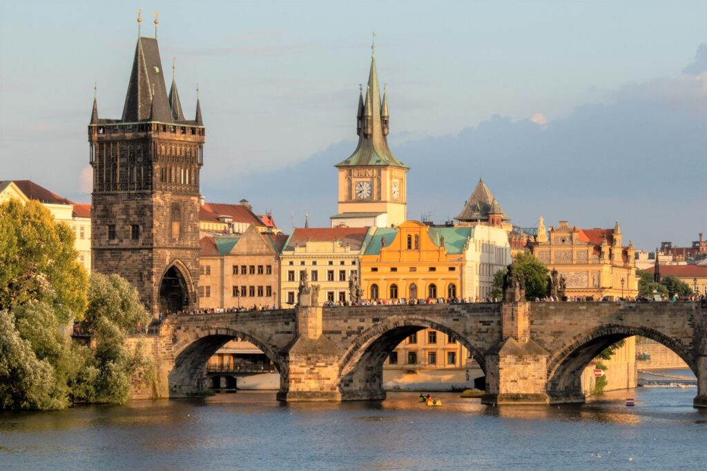 The prestigious Charles Bridge standing mighty across the River Vltava surrounded by Prague's architecture.