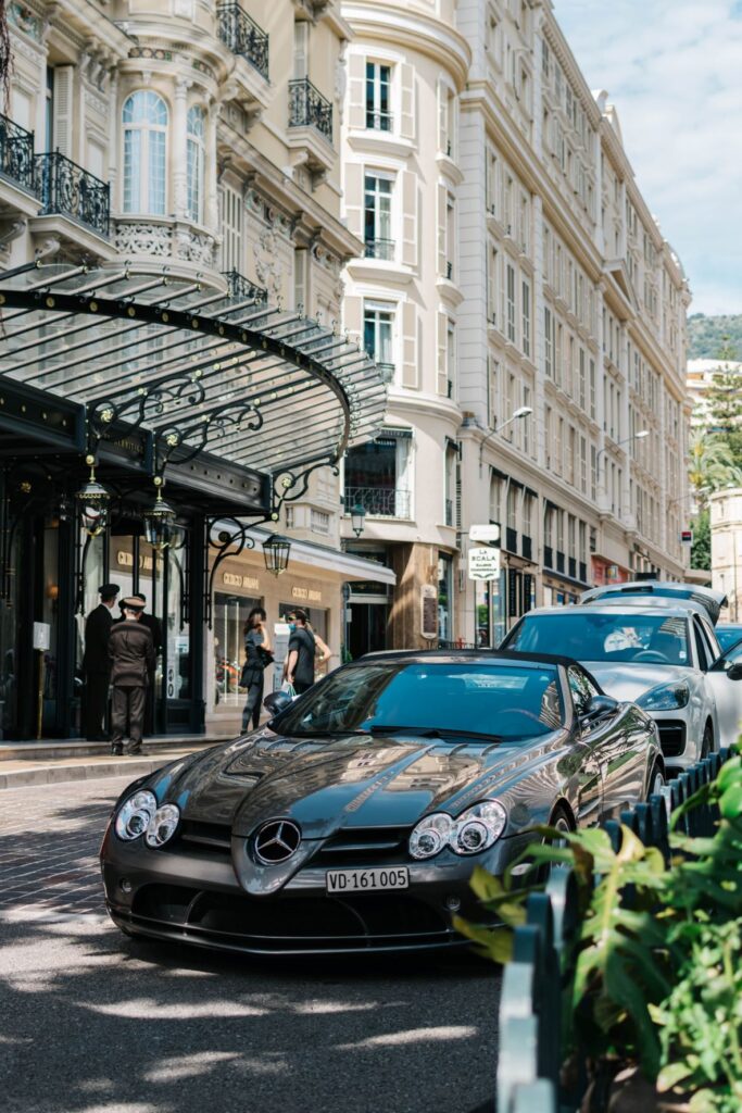 black mercedes parked on street outside a fancy hotel during the daytime