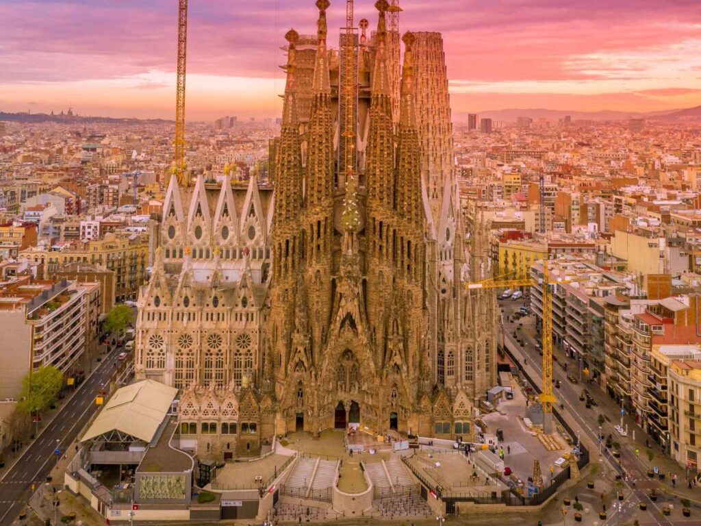brown concrete building known as La Sagrada Familia sitting in the heart of Barcelona city
