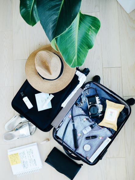 SUITCASE WITH HAT AND OTHER BELONGINGS