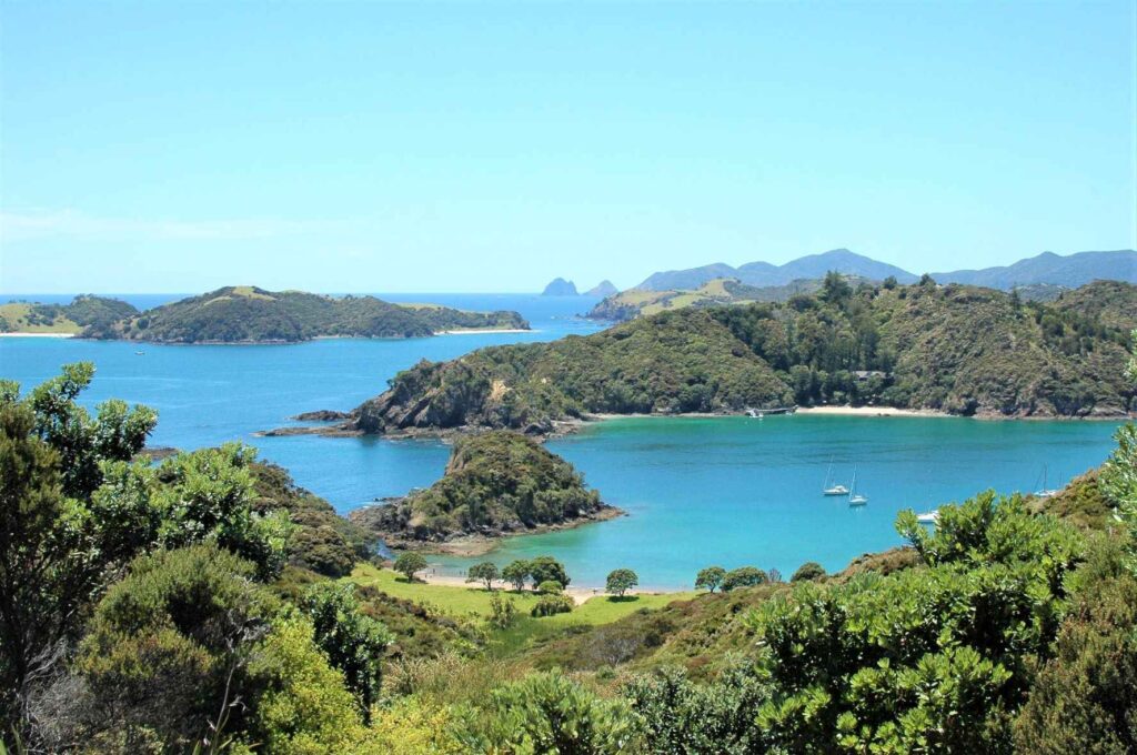 Ariel shot of green covered mountains   and small islands and the sea during daytime