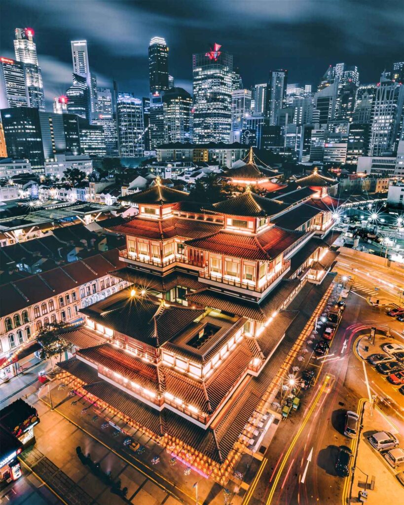 Arial shot of buddha tooth relic temple lit up during nighttime. One of the best things to do in Singapore