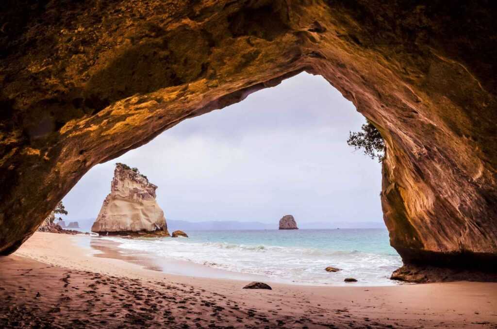 brown rocks with a view to the water and sand all around