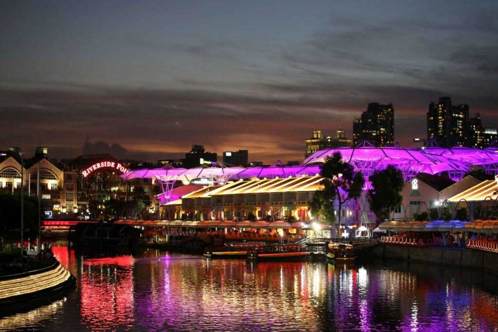 body of water near lit up buildings during nighttime