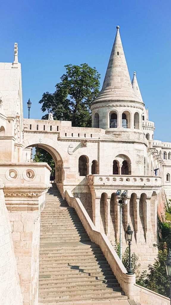 beige castle during daytime. popular tourist attraction considered one of the best things to do in Budapest