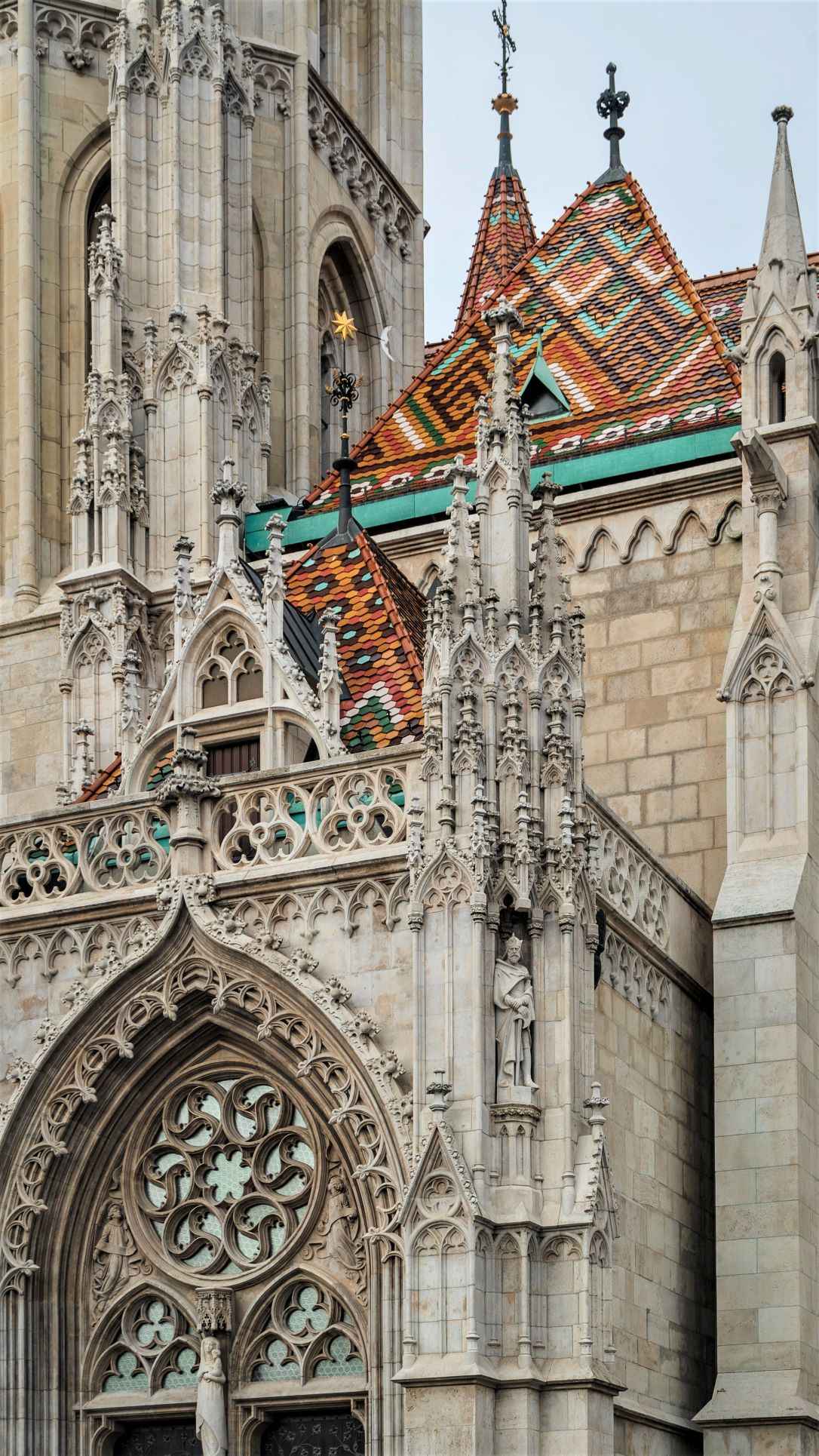 close up photo of beige cathedral with orange and blue tiled roof and intricate work done through it