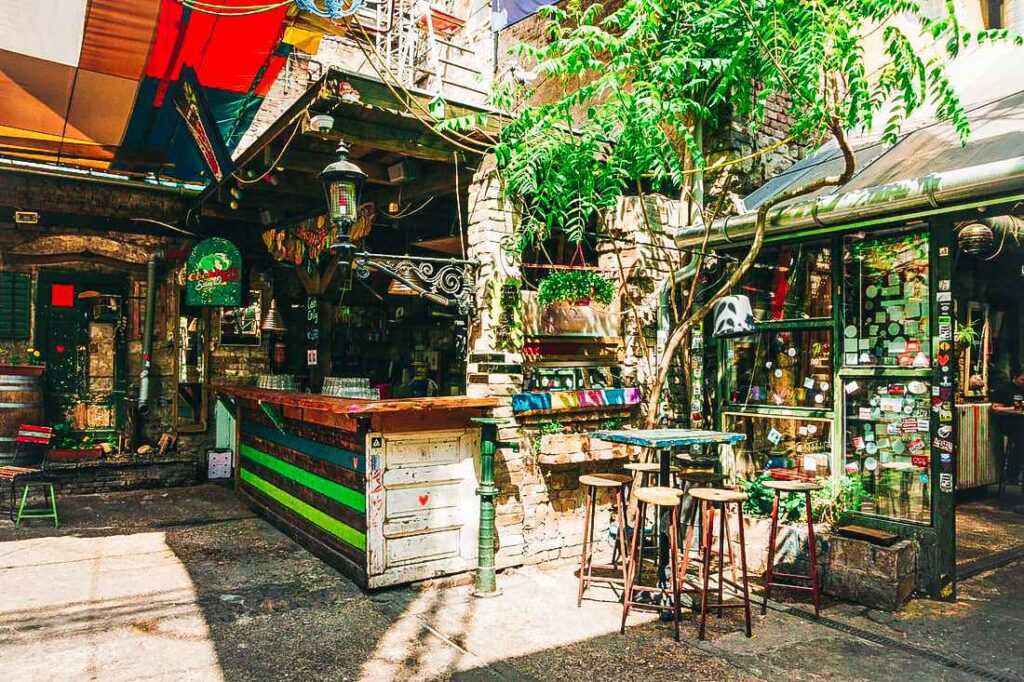 outdoor area with table and bar stools, bar area during daytime