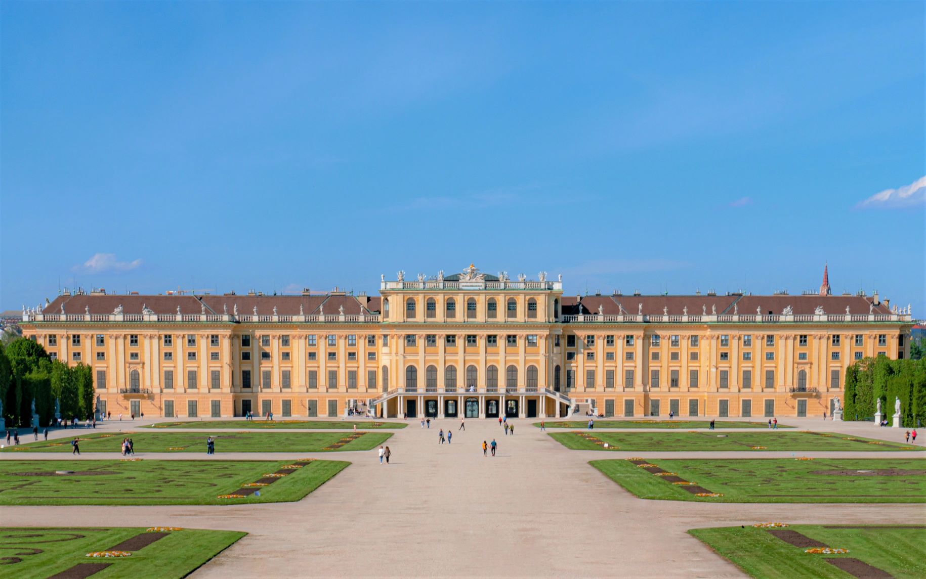 Yellow and Brown concrete palace in a large courtyard with green grass during day time