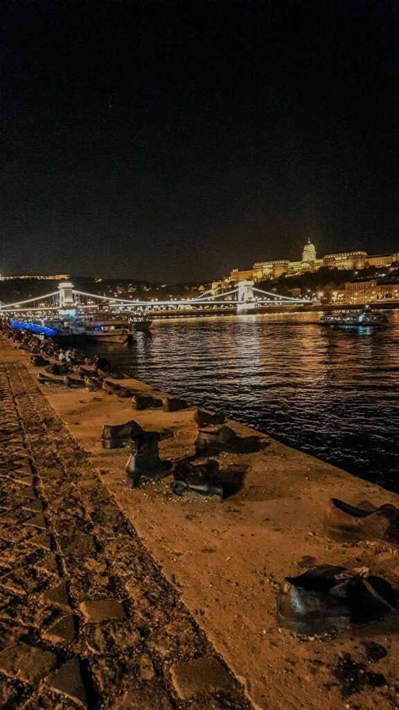 cast iron shoes laid on the edge of a river during night time