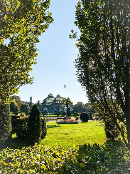 green park with glass house during daytime