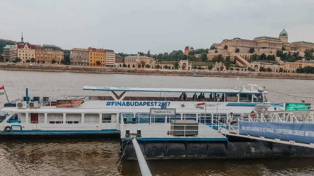 boat in water near concrete buildings