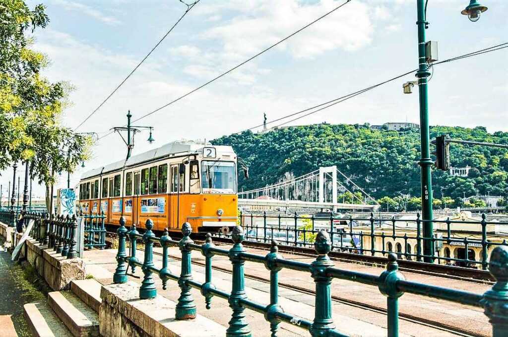 yellow tram on tracks during day time