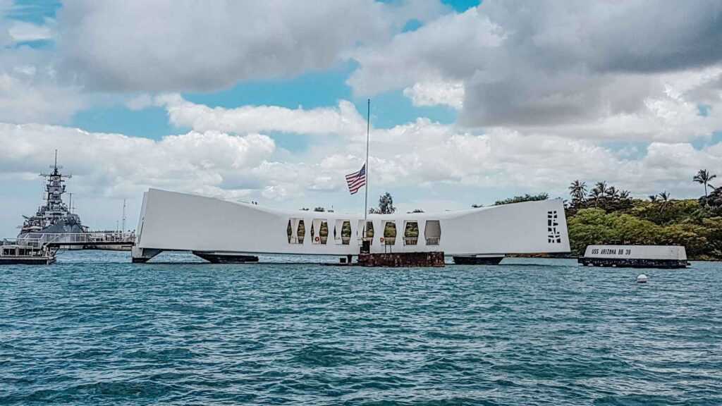 white concrete structure sitting on blue water during daytime