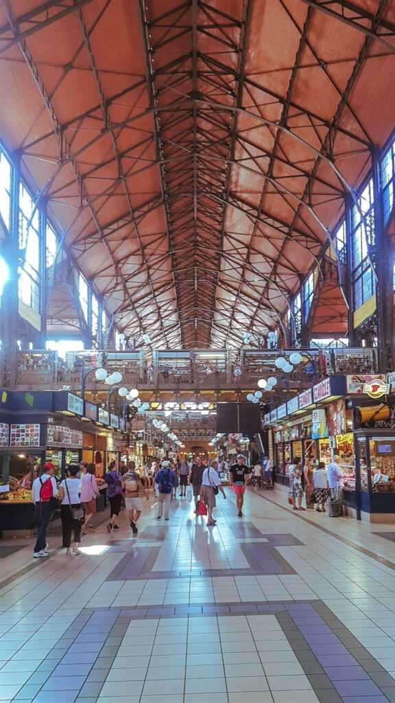 indoor food hall with people walking around and food stalls