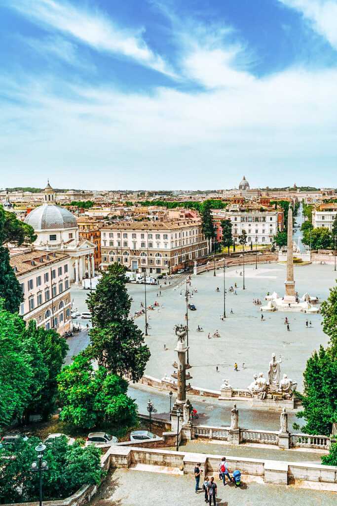 Arial view of a square with buildings surrounding it and people walking through it