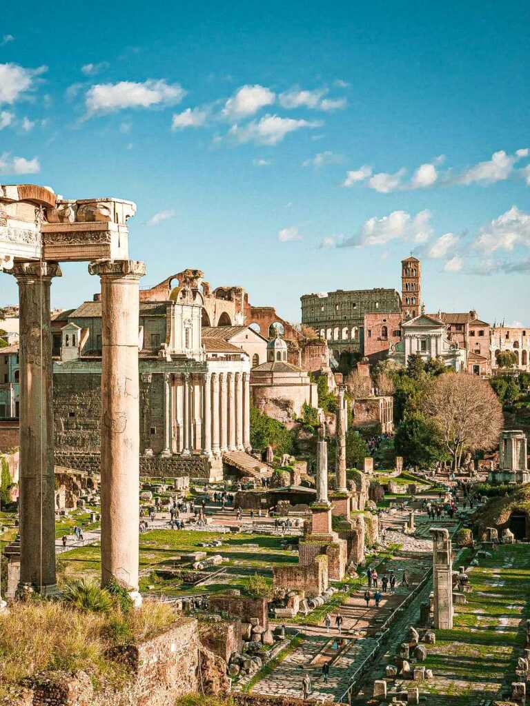 arial view of concrete columns and structures amongst green grass during day time. One of the best places to visit in Rome 