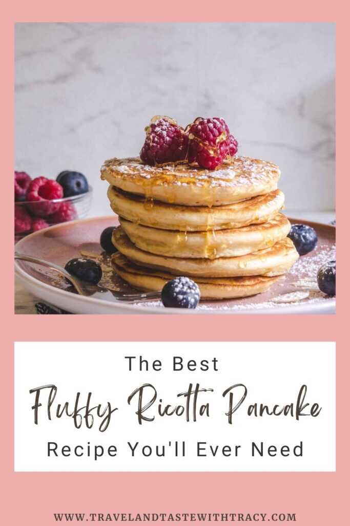 photo of stacked fluffy ricotta pancakes topped with fruit on a plate. The best fluffy ricotta pancake recipe