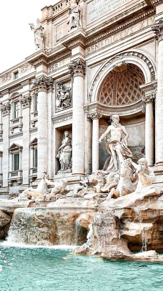 White concrete fountain structure with body of water during daytime. popular attraction to visit in Rome