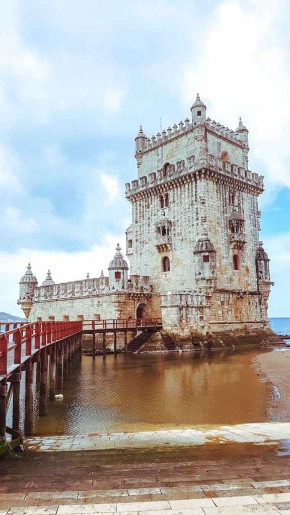 Brown concrete structure sitting over a body of water during daytime. one of the best things to do during your two weeks in Portugal