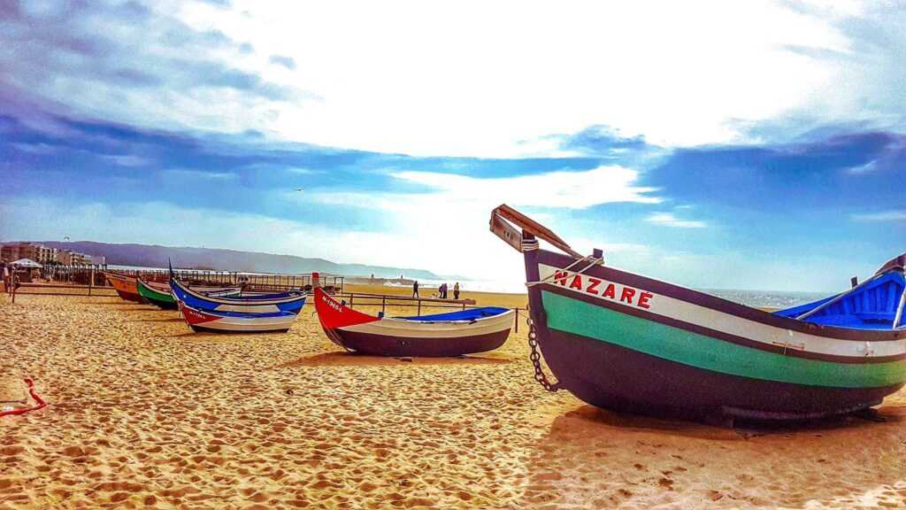 Colorful Boats sitting on golden sand during daytime