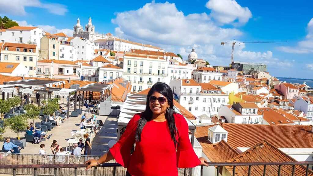 Beautiful neighborhood of Alfama with white houses and orange roofs during daytime. one of the best places to visit in Lisbon