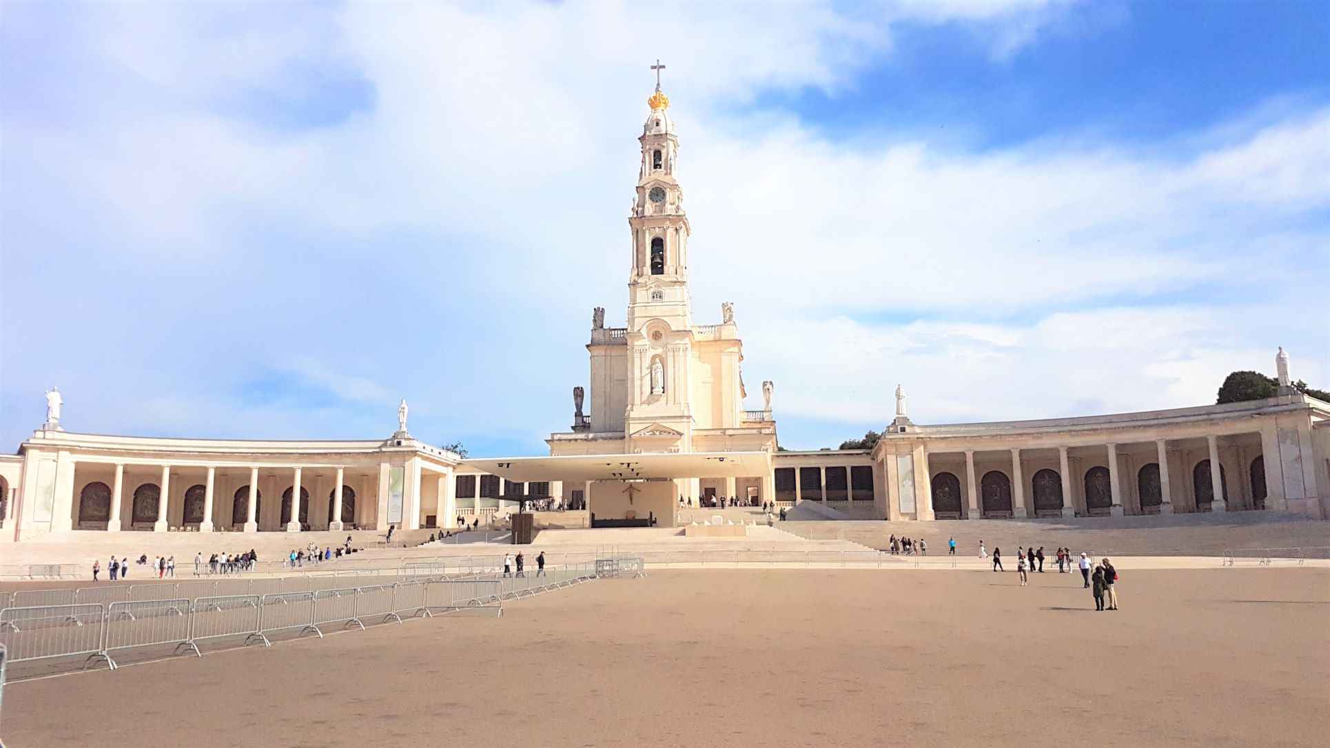 White concrete structure in a large square during daytime. One of the most religious and famous landmarks in Portugal