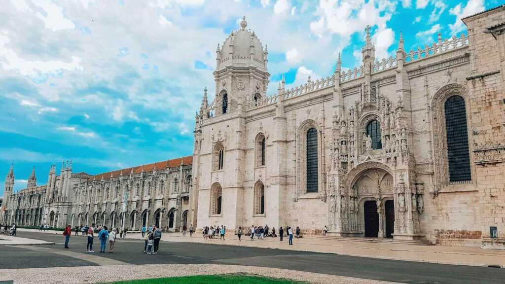 Beige concrete building with intricate carvings during daytime. one of the best places to visit in Lisbon