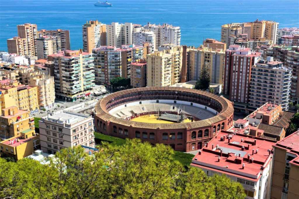 Ariel view of city buildings and bull ring during daytime