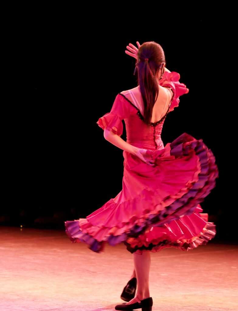 Woman in red dress dancing during night time