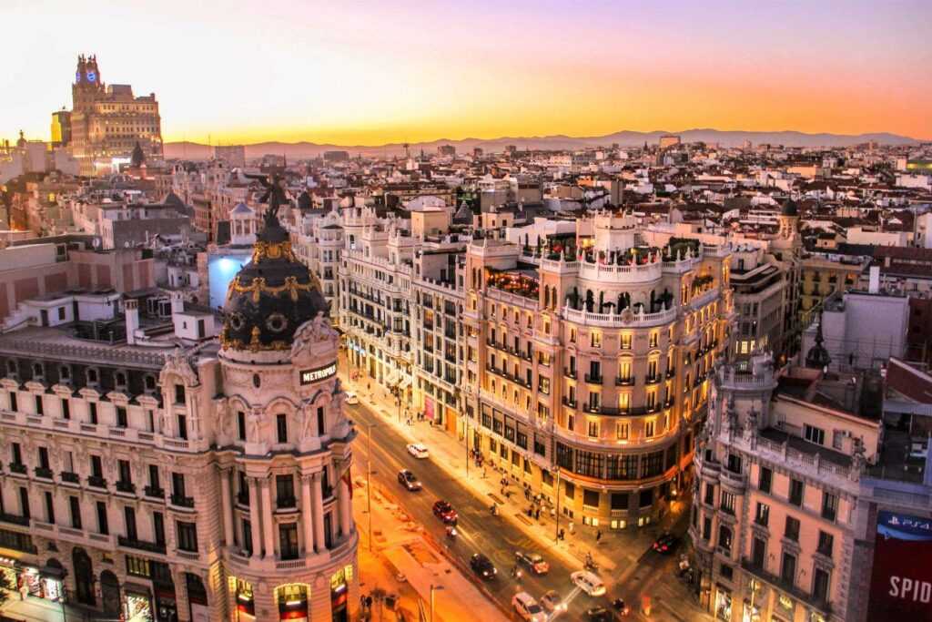 Arial shot of high rise concrete buildings during sunset. one of the best places to visit in Madrid