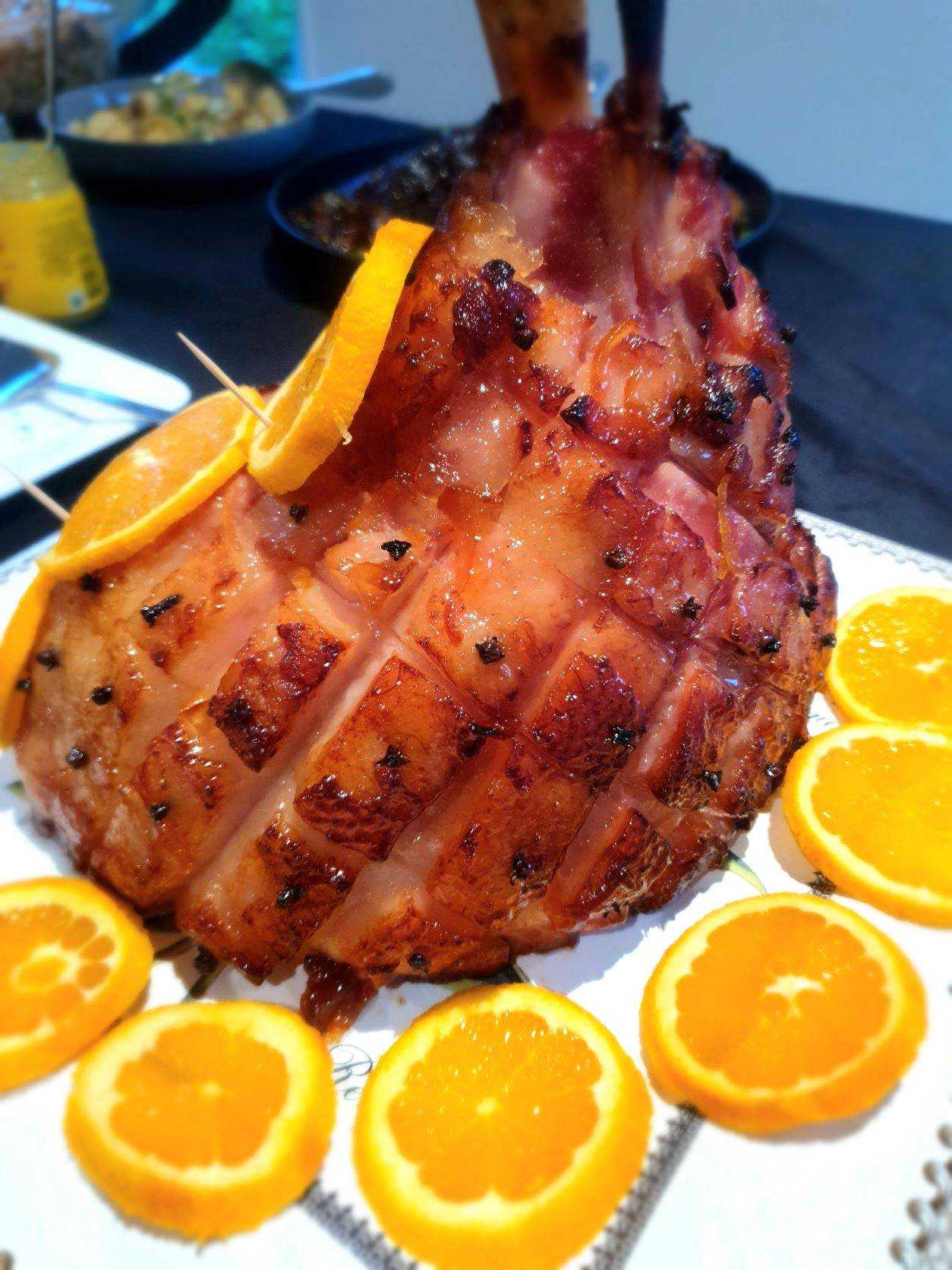 Piece of meat on the bone covered in orange slices