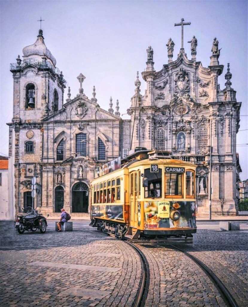 Concrete building with a yellow tram infront of it during daytime