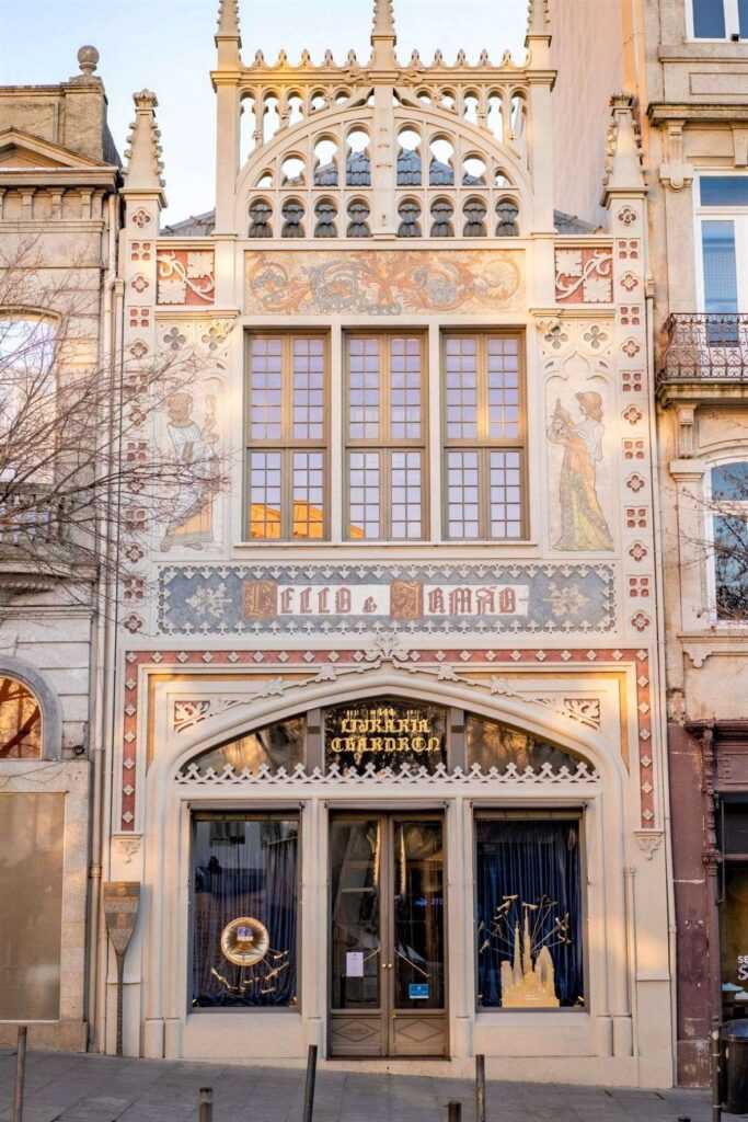 Brown concrete building with glass windows during daytime. One of the best places to visit in Porto