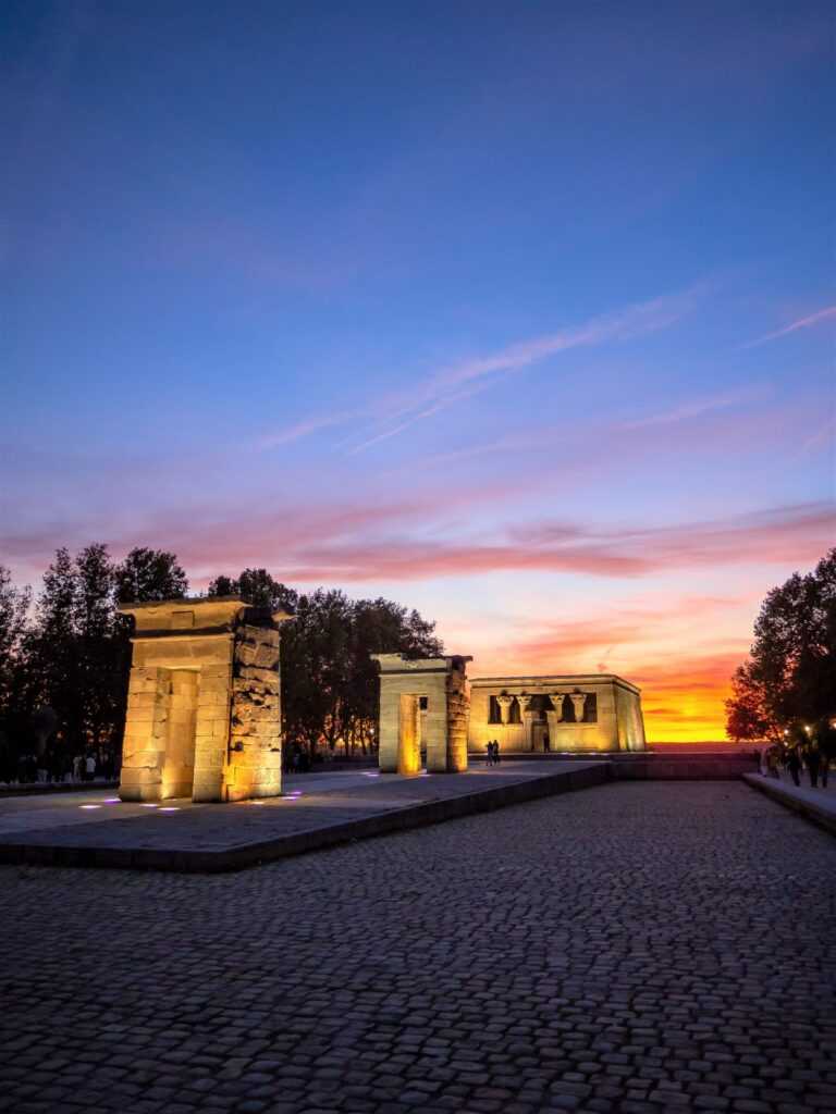 concrete stone structures sitting on a body of water during sunset