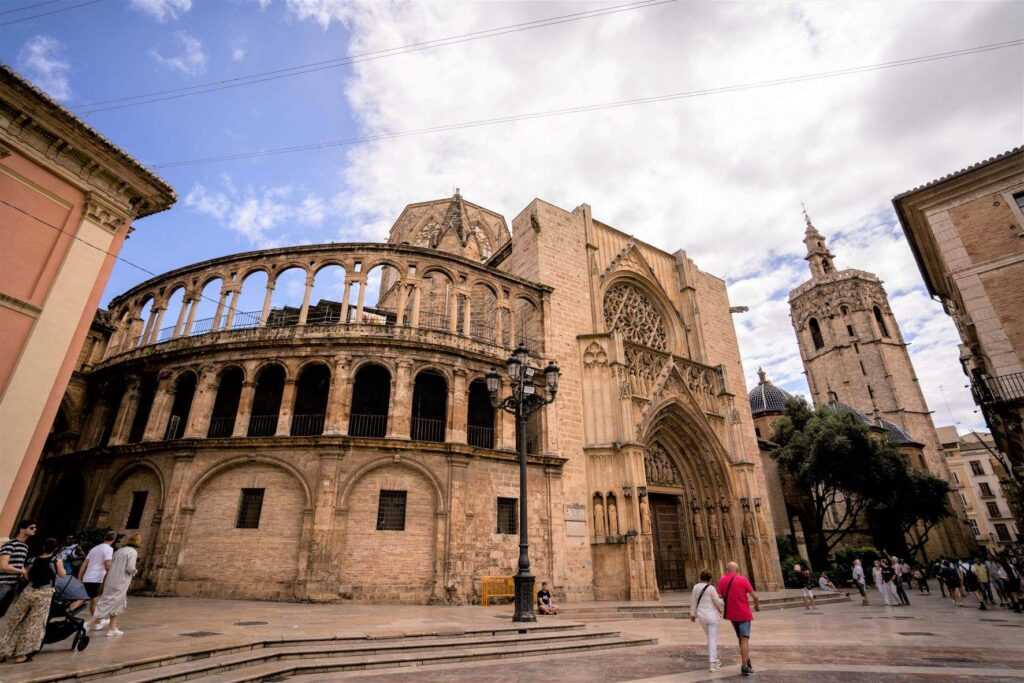 Brown structure during daytime with people walking in front of it