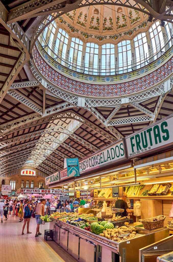 People walking inside fruit market during daytime