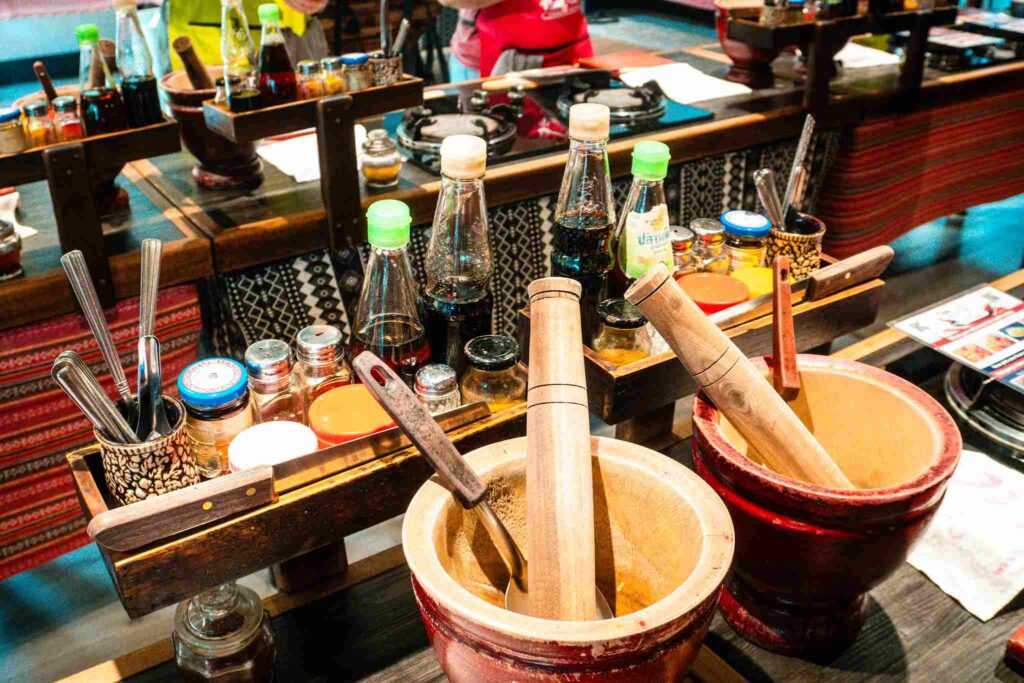 Motar and Pestal on a kitchen bench with other cooking equipment