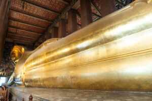 Gold reclining Buddha statue inside a temple.One of the famous temples in bangkok