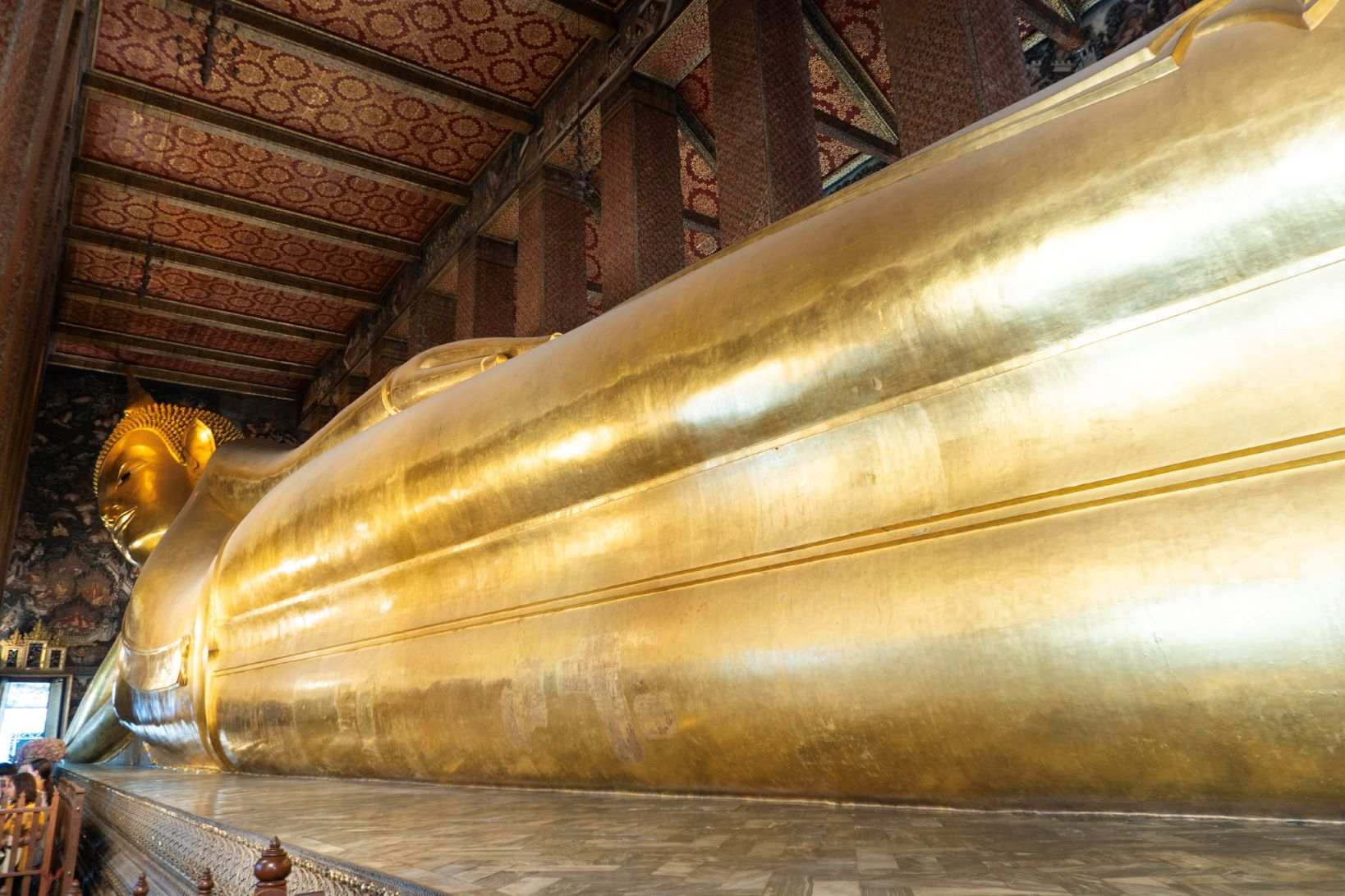 Gold reclining Buddha statue inside a temple.One of the famous temples in bangkok