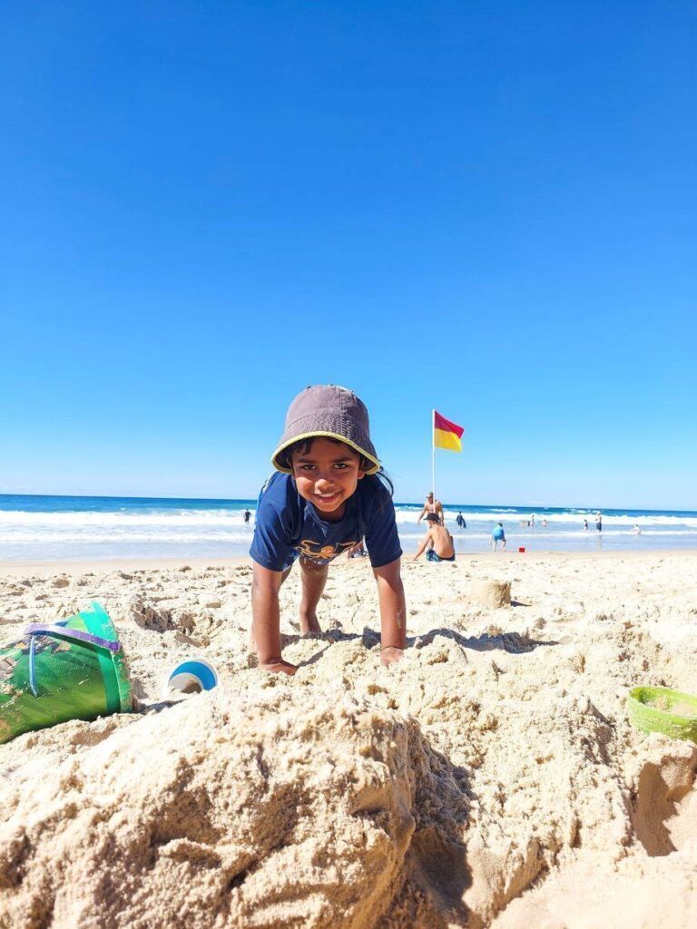 Boy on beach during day time