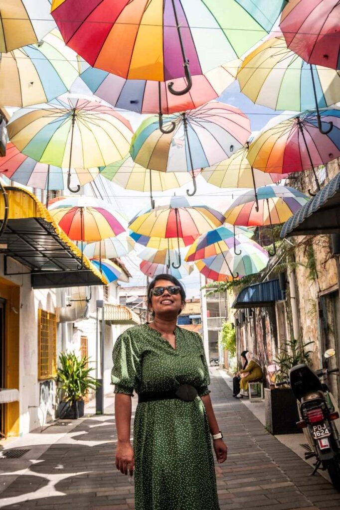 girl standing under umbrellas during daytime