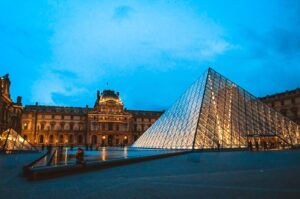 Glass triangle near building during night time