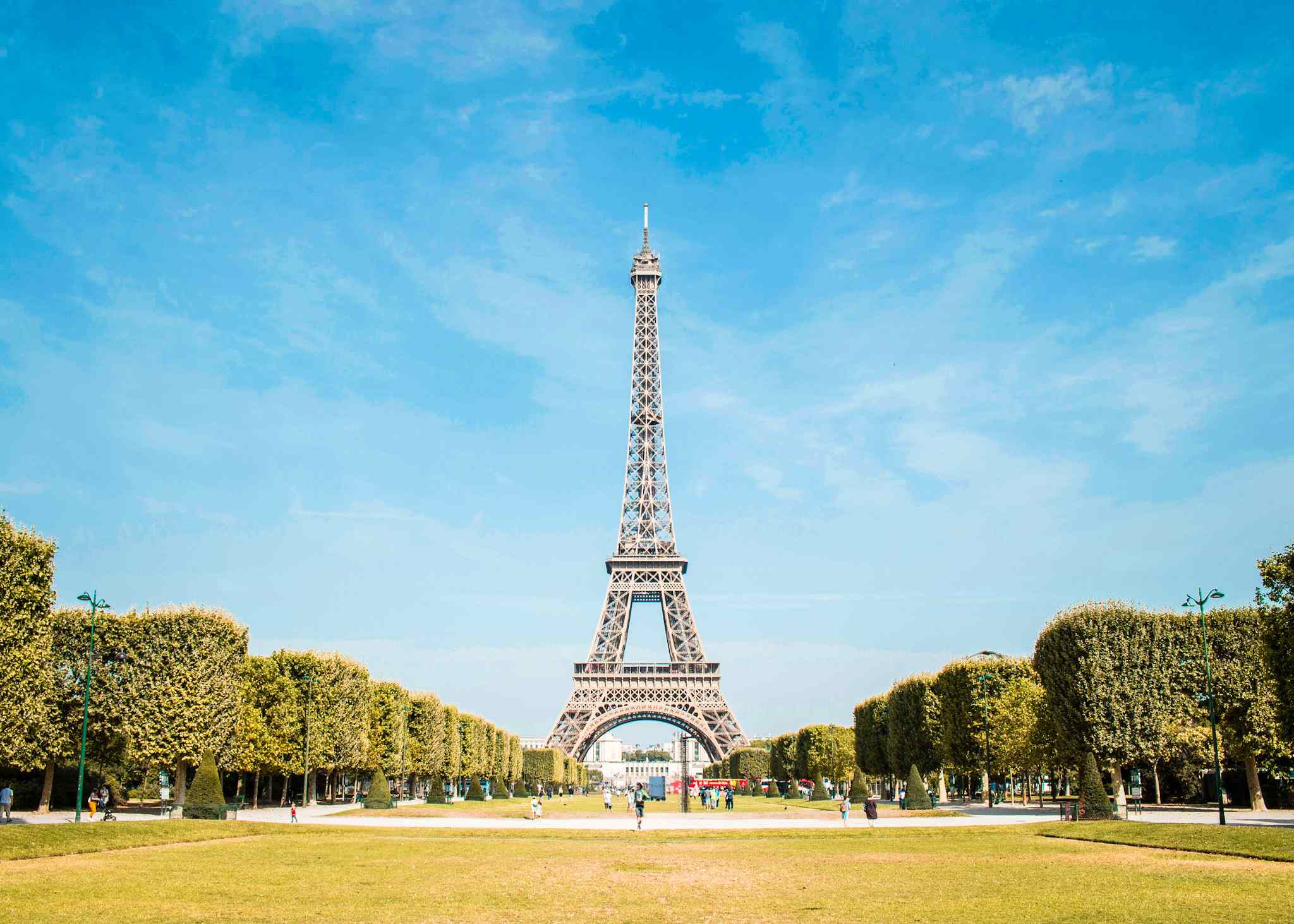 tall copper structure surroundecd by green trees and lawn during daytime